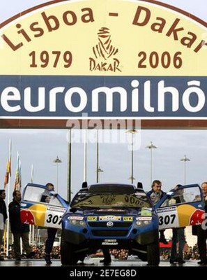 spains-driver-carlos-sainz-r-leaves-his-car-accompanied-by-his-german-co-driver-andreas-schulz-l-on-their-volkswagen-touareg-car-at-the-start-of-the-28th-edition-of-the-dakar-rally-in-lisbon-december-31.jpg
